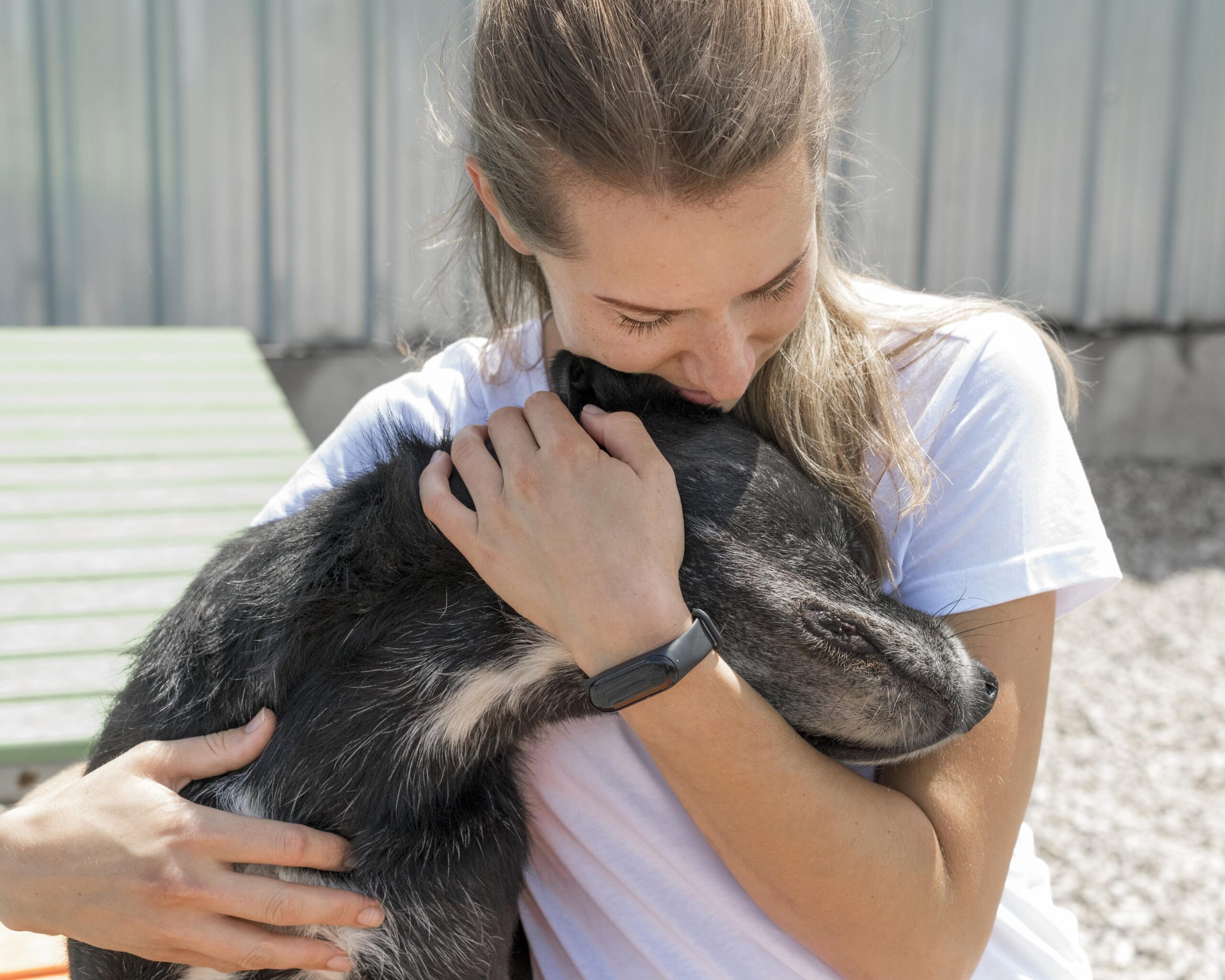 woman hugging cute rescue dog